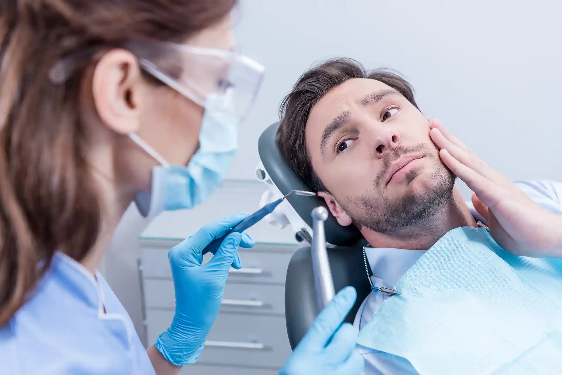 man getting dental exam by a dentist