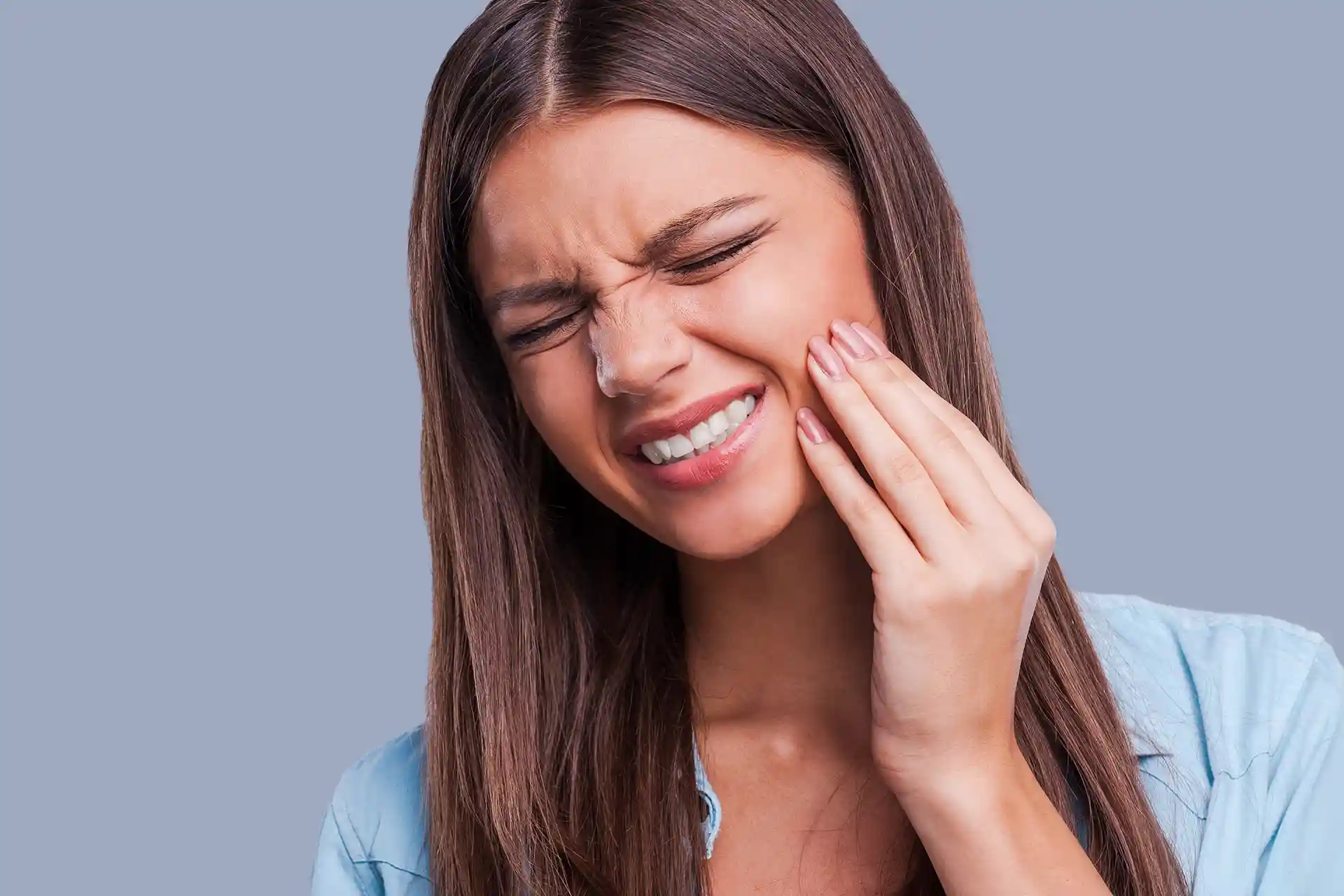 young woman experiencing intense jaw pain